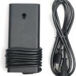 Black rectangular laptop power adapter with its cord wrapped around the brick and a detachable AC power cord beside it.