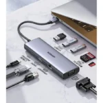 Slim aluminum USB-C hub connected to a laptop, with HDMI, USB-A, VGA, and card slots available