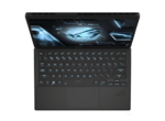 Top-down view of a black gaming laptop open, showing a futuristic blue-lit keyboard and holographic display on the screen
