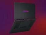 Black Legion gaming laptop shown from a tilted rear angle, with purple accent lighting along the hinge/vents against a gradient background.