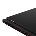 Back edge of a black laptop with red accents showing USB ports and HDMI