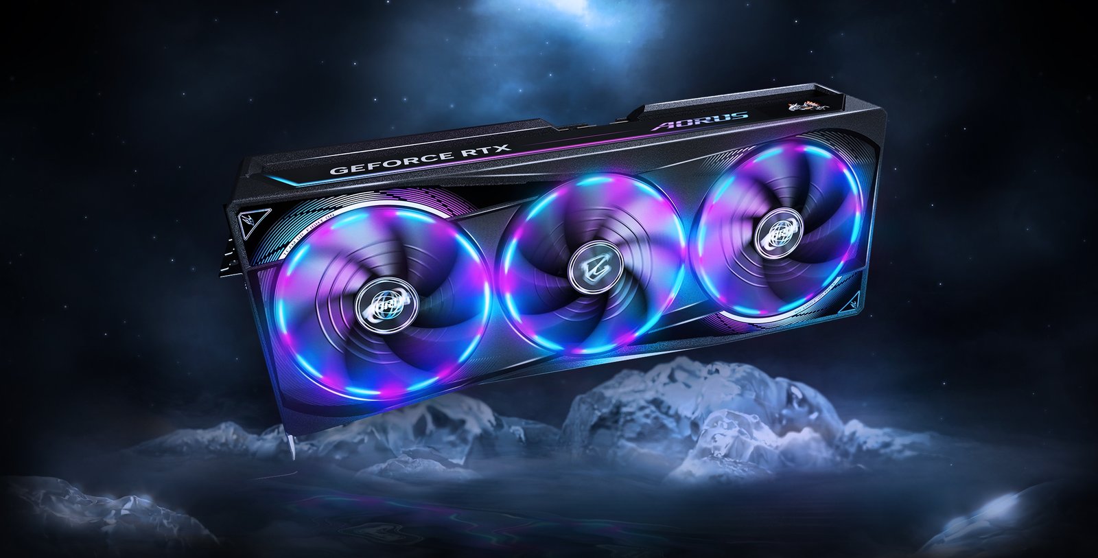 GeForce RTX graphics card with three RGB-lit fans, branded AORUS, floating in space above icy mountains. | Ahoundjuè Technologies LA PUISSANCE À TRAVERS LE JEU