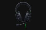 Black over-ear gaming headset with adjustable headband and boom microphone on a dark background.