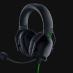 Black over-ear gaming headset with attached mic on a dark background, wired with a green accent cable (Razer branding). Popular for immersive audio.