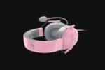 Pink over-ear gaming headset with attached microphone, gray cushions, and a curved headband on a black background.